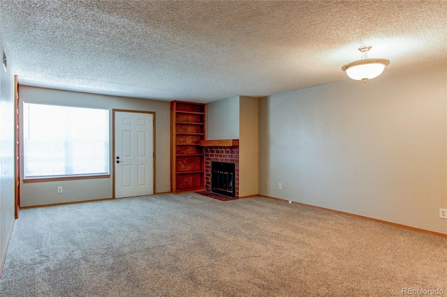 2690 E Otero Pl Unit 7, Centennial, CO 80122 - unfurnished living room with carpet flooring, baseboards, a tiled fireplace, and a textured ceiling