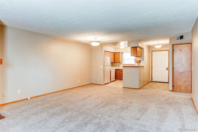 2690 E Otero Pl Unit 7, Centennial, CO 80122 - unfurnished living room with light carpet, baseboards, and a textured ceiling