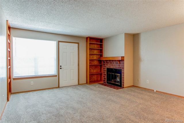 2690 E Otero Pl Unit 7, Centennial, CO 80122 - unfurnished living room featuring carpet floors, a tiled fireplace, baseboards, and a textured ceiling
