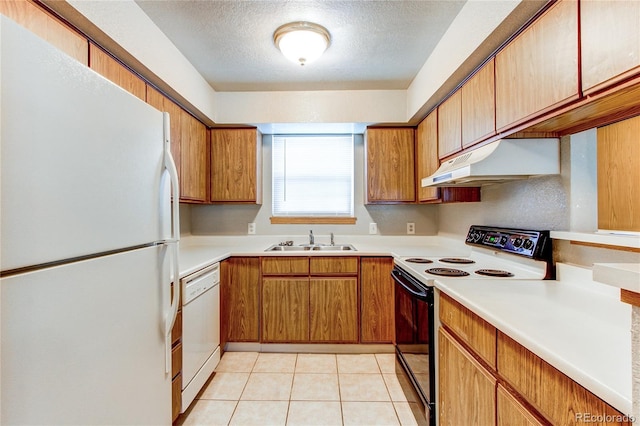 2690 E Otero Pl Unit 7, Centennial, CO 80122 - kitchen with white appliances, under cabinet range hood, a sink, light countertops, and a textured ceiling