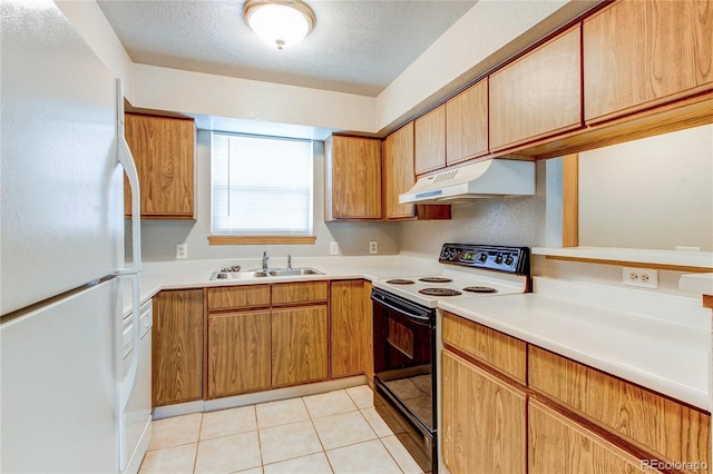 2690 E Otero Pl Unit 7, Centennial, CO 80122 - kitchen with under cabinet range hood, freestanding refrigerator, range with electric stovetop, a sink, and light countertops