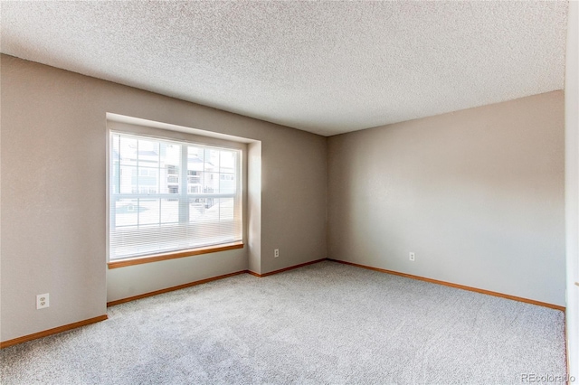 2690 E Otero Pl Unit 7, Centennial, CO 80122 - spare room with carpet flooring, baseboards, and a textured ceiling