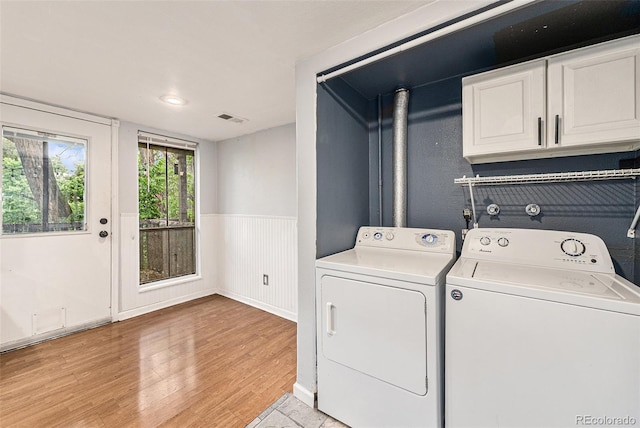 3550 S Harlan St Unit 105, Denver, CO 80235 - laundry room with washing machine and dryer, light wood finished floors, wainscoting, and cabinet space