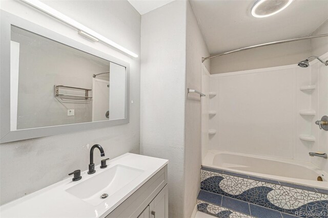 3550 S Harlan St Unit 105, Denver, CO 80235 - bathroom with vanity and tiled shower / bath combo
