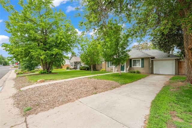 1221 Ulster St, Denver, CO 80220 - view of property hidden behind natural elements with a garage and concrete driveway
