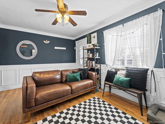 1221 Ulster St, Denver, CO 80220 - living area featuring a wainscoted wall, ceiling fan, and wood finished floors