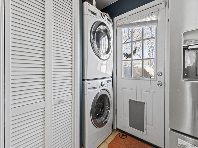1221 Ulster St, Denver, CO 80220 - laundry area featuring stacked washer / drying machine and tile patterned floors