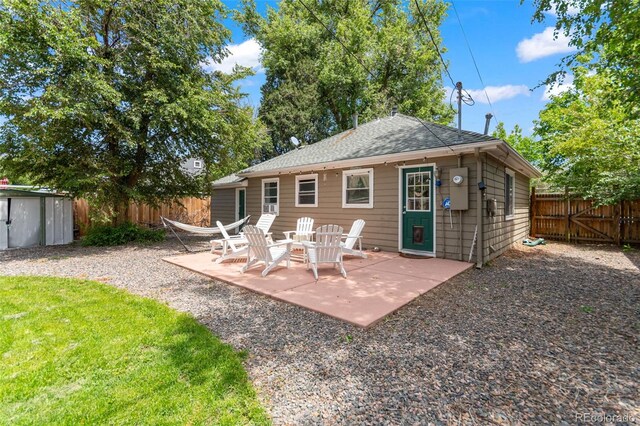 1221 Ulster St, Denver, CO 80220 - rear view of house with a fenced backyard, a patio area, and roof with shingles
