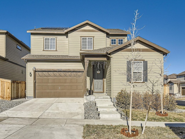 view of front of home with solar panels and a garage