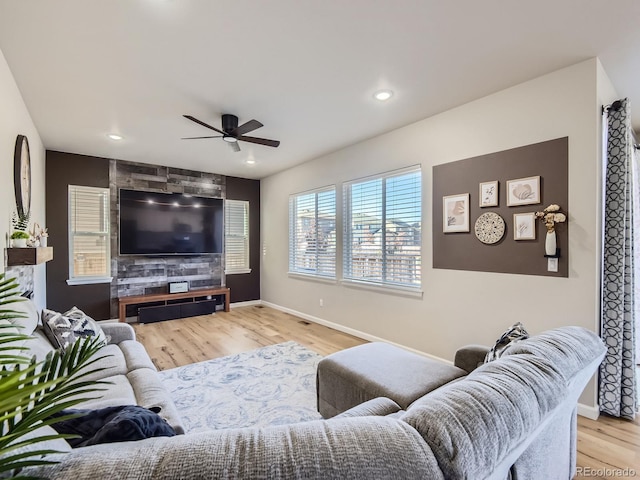 living room featuring light wood-type flooring and ceiling fan