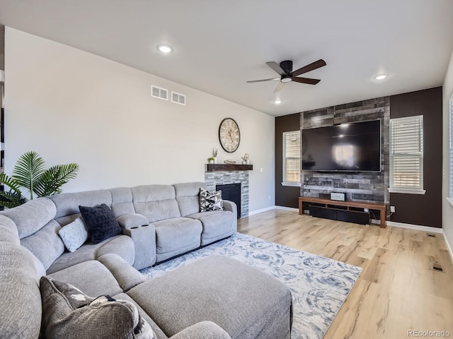 living room featuring hardwood / wood-style floors, ceiling fan, a healthy amount of sunlight, and a fireplace