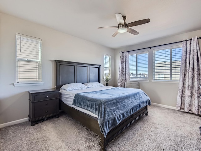 bedroom featuring carpet, ceiling fan, and multiple windows