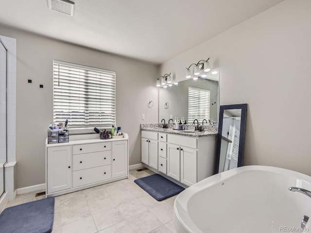 bathroom featuring plus walk in shower, vanity, and tile patterned flooring