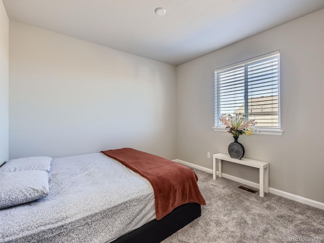 bedroom featuring light carpet