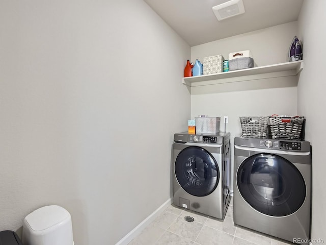 washroom with independent washer and dryer and light tile patterned floors