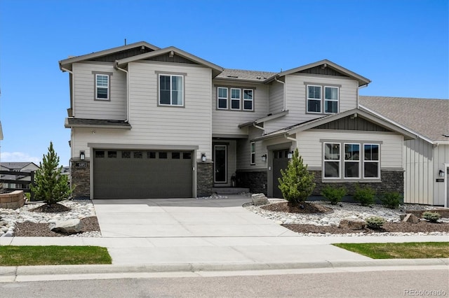 craftsman-style house with concrete driveway, board and batten siding, stone siding, and a garage