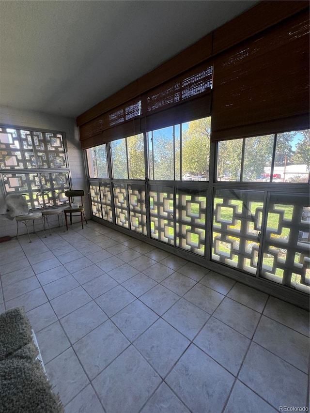 unfurnished sunroom with a wealth of natural light