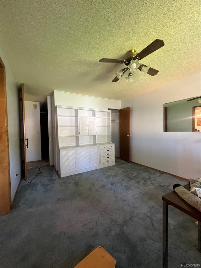 unfurnished bedroom featuring ceiling fan, carpet flooring, and a textured ceiling