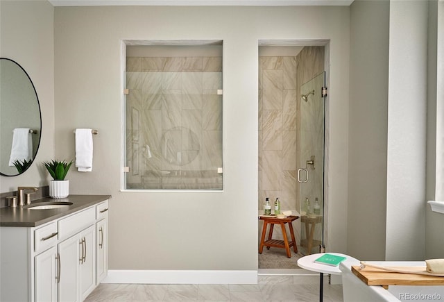 bathroom with vanity and a shower with shower door