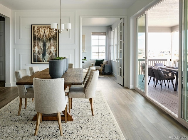 dining room with an inviting chandelier and light wood-type flooring