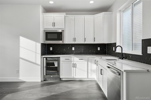 16549 Black Rose Cir, Parker, CO 80134 - kitchen with stainless steel dishwasher, a sink, beverage cooler, built in microwave, and backsplash