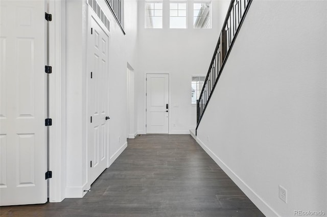 16549 Black Rose Cir, Parker, CO 80134 - hallway featuring dark wood finished floors, a wealth of natural light, baseboards, and stairway