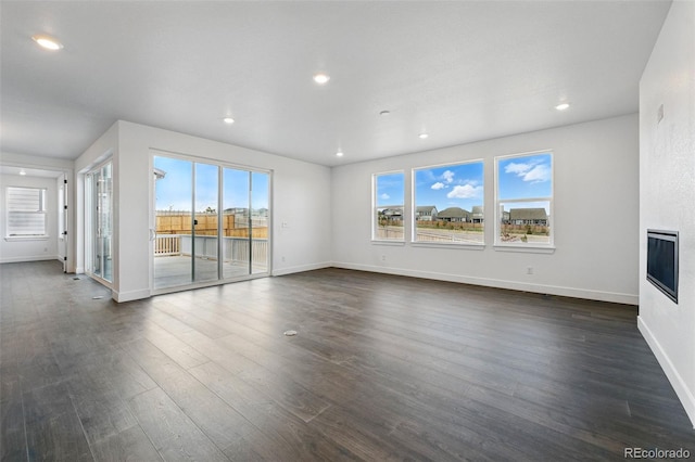 16549 Black Rose Cir, Parker, CO 80134 - unfurnished living room featuring dark wood-style floors, baseboards, and recessed lighting