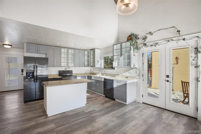 kitchen with a center island, french doors, sink, gray cabinets, and black appliances