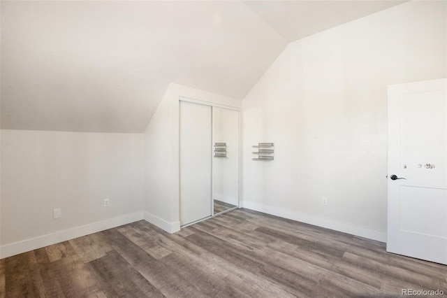 additional living space with wood-type flooring and lofted ceiling