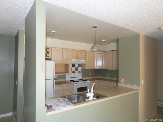 kitchen featuring a textured ceiling, white appliances, sink, and decorative light fixtures