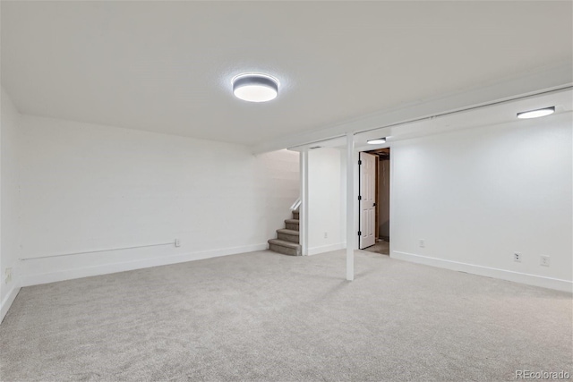 basement featuring light carpet