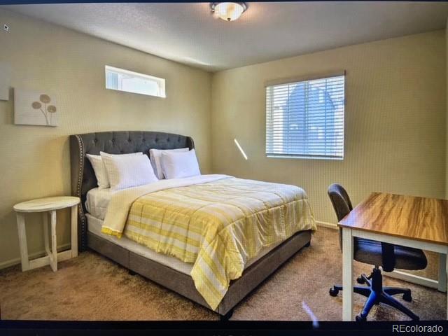 bedroom featuring multiple windows and carpet