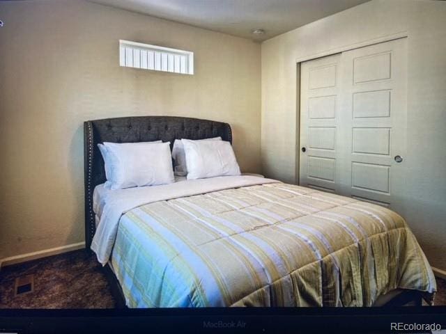 bedroom featuring carpet and a closet