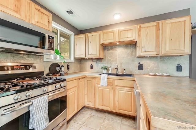 162 Pine Trl, Bailey, CO 80421 - kitchen featuring light brown cabinets, appliances with stainless steel finishes, and decorative backsplash