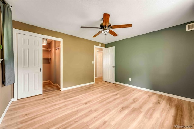 162 Pine Trl, Bailey, CO 80421 - unfurnished bedroom with light wood finished floors, a ceiling fan, and a spacious closet