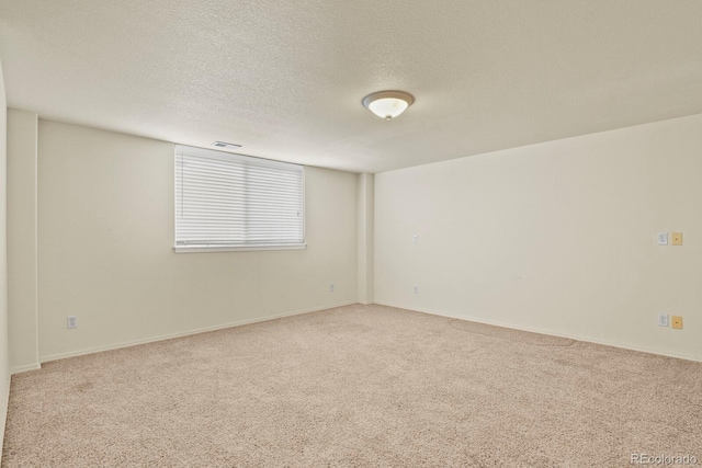 spare room with carpet floors and a textured ceiling