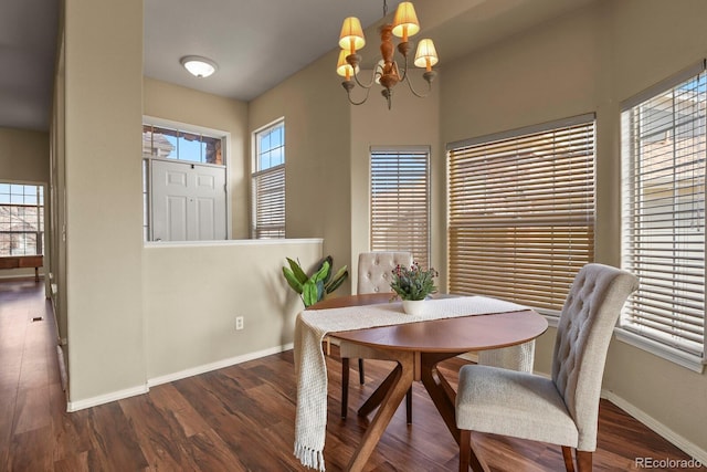 dining area featuring dark hardwood / wood-style flooring and a chandelier