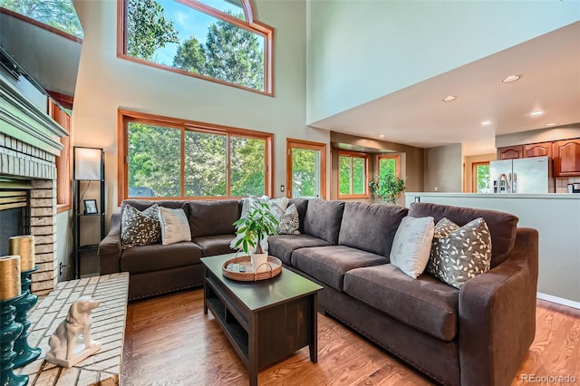 360 Morning Star Ln, Lafayette, CO 80026 - living area featuring light wood-type flooring, a towering ceiling, and recessed lighting