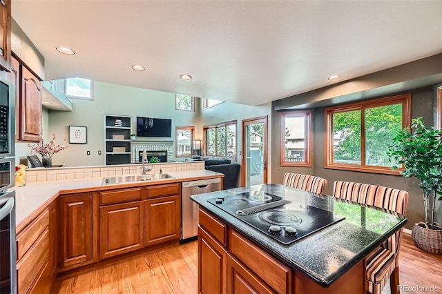 360 Morning Star Ln, Lafayette, CO 80026 - kitchen featuring dishwasher, brown cabinets, light wood finished floors, a peninsula, and recessed lighting