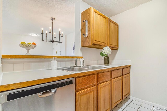 2231 S Vaughn Way Unit 317B, Aurora, CO 80014 - kitchen with dishwasher, light tile patterned floors, light countertops, a chandelier, and a textured ceiling
