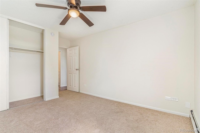 2231 S Vaughn Way Unit 317B, Aurora, CO 80014 - unfurnished bedroom with baseboard heating, carpet floors, a closet, and a ceiling fan