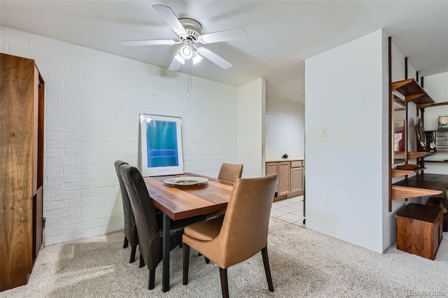 460 S Marion Pkwy Unit 102, Denver, CO 80209 - dining space with a ceiling fan, light colored carpet, and brick wall