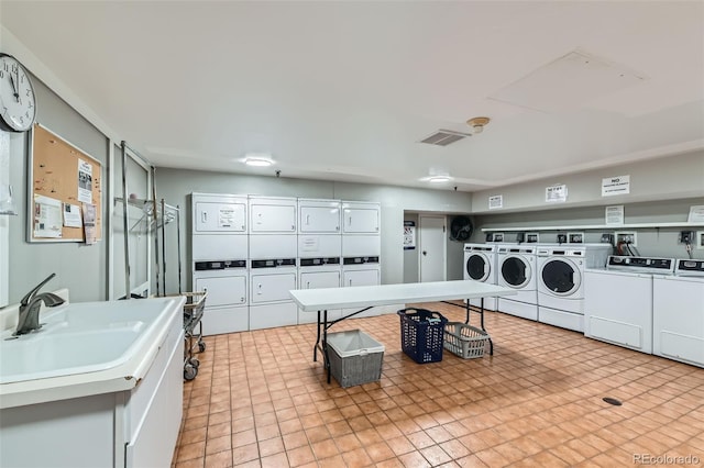 460 S Marion Pkwy Unit 102, Denver, CO 80209 - shared laundry room featuring stacked washing machine and dryer and washing machine and clothes dryer