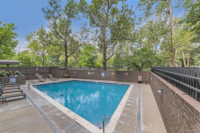 460 S Marion Pkwy Unit 102, Denver, CO 80209 - community pool with view of wooded area and a patio area