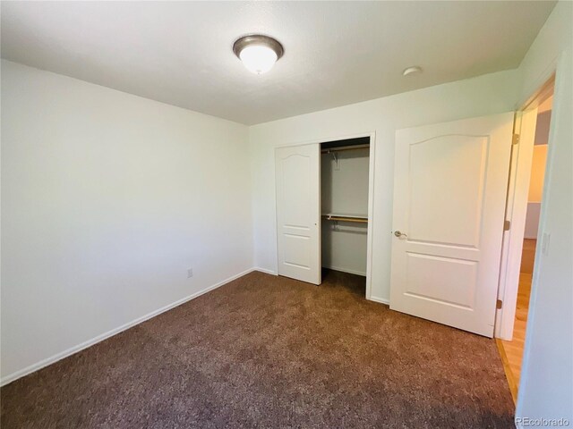 unfurnished bedroom with carpet and a closet