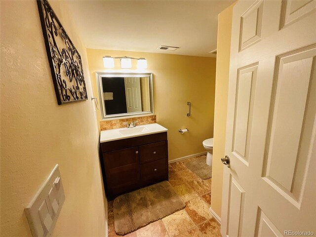 bathroom featuring tile patterned floors, vanity, and toilet