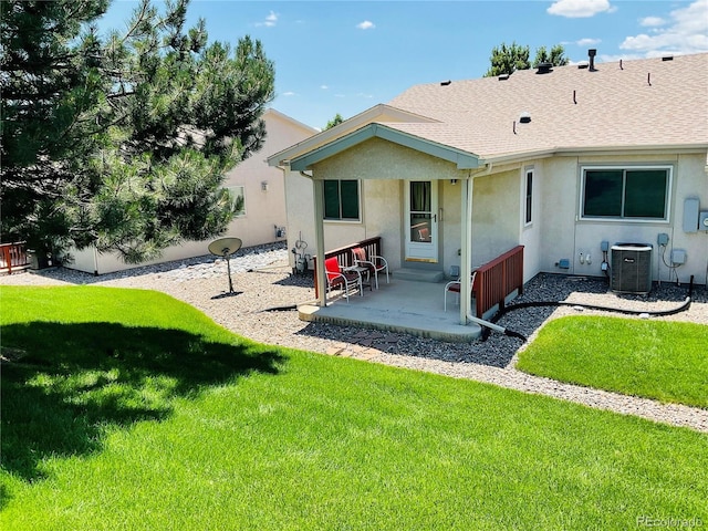 rear view of property featuring a patio, cooling unit, and a lawn