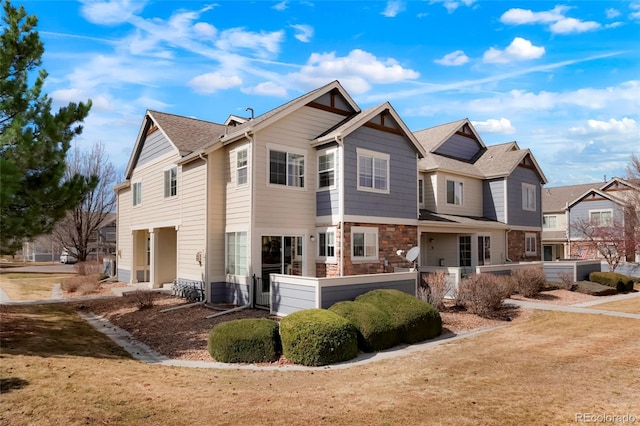 exterior space featuring stone siding and a residential view