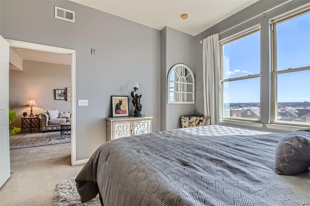 carpeted bedroom with visible vents and baseboards