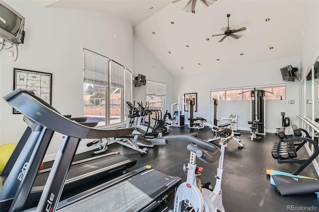 gym with baseboards, high vaulted ceiling, and a ceiling fan